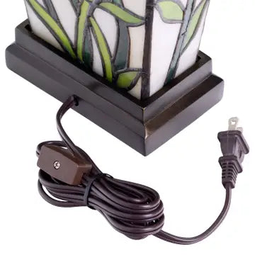 Decorative floral vase shaped table lamp with stained glass design and power cord on a white background.